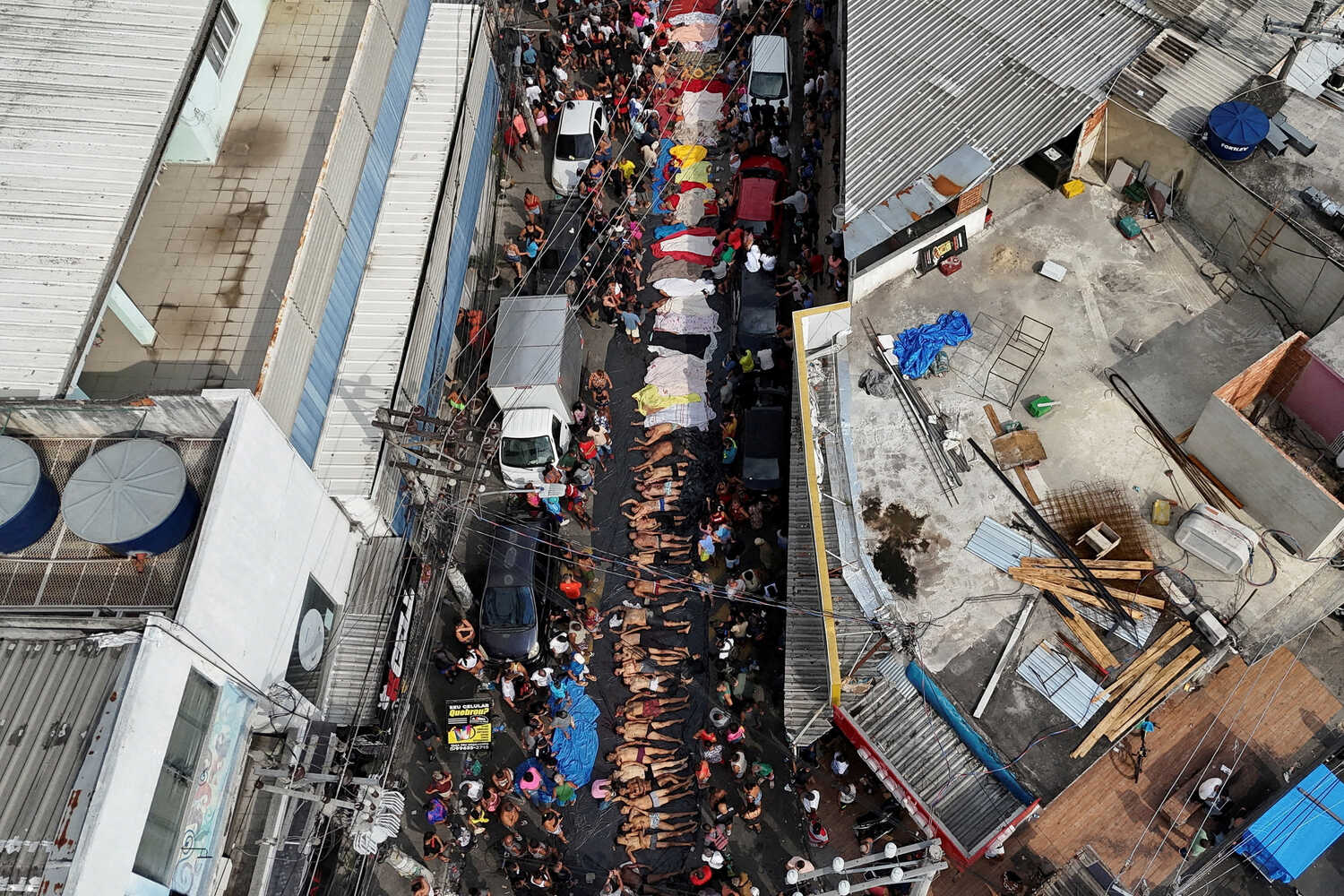 Bodies of people lay on a street.