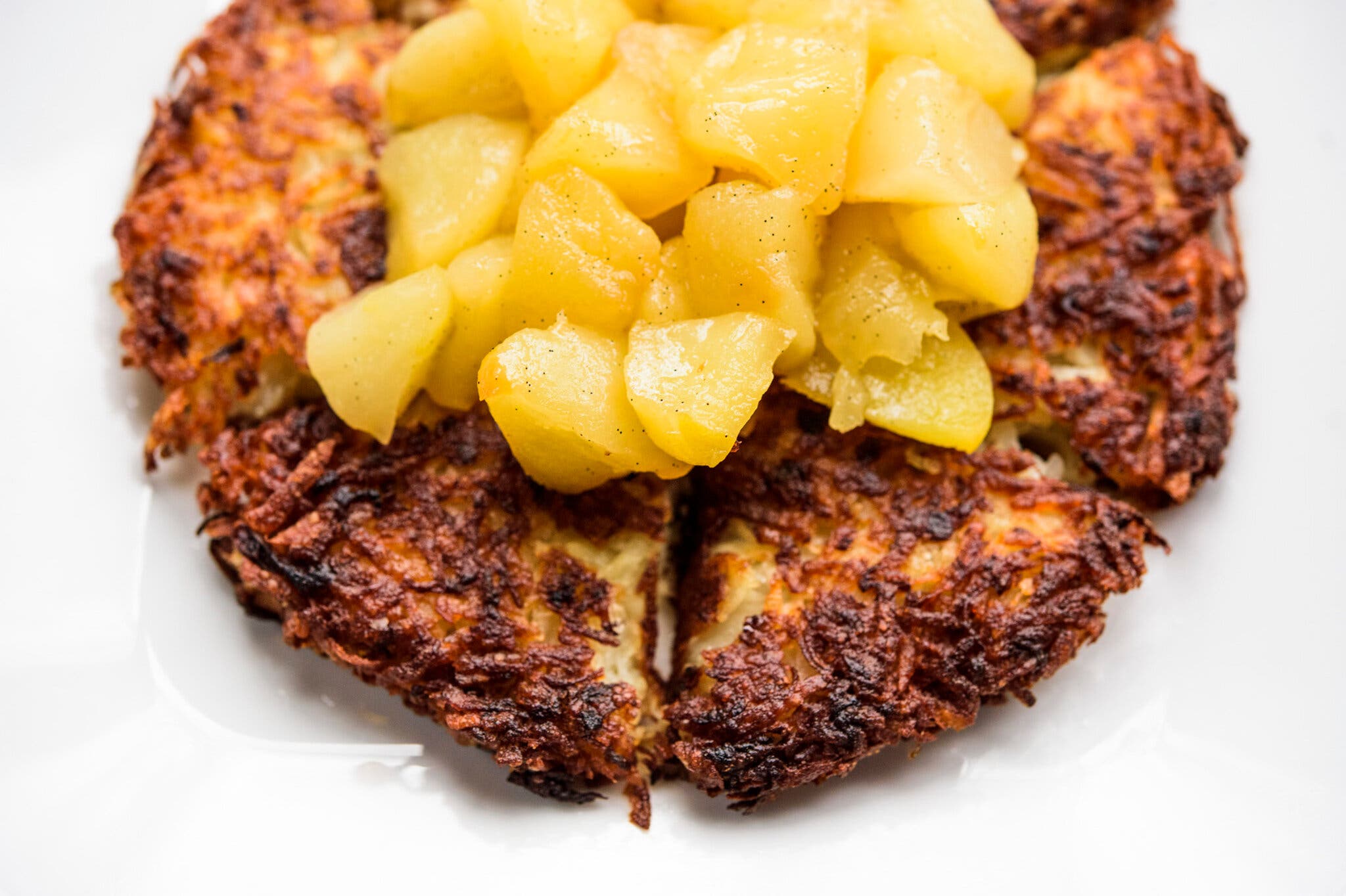 A large potato pancake topped with tender cooked apples.